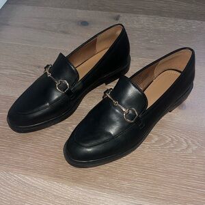 Black loafers with gold chain